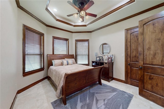 bedroom featuring baseboards, a ceiling fan, a tray ceiling, and ornamental molding