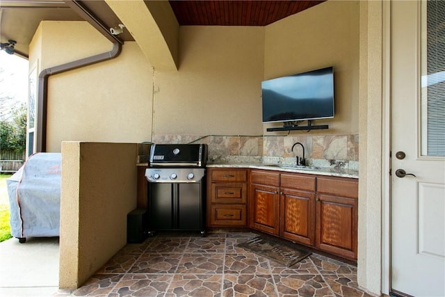 view of patio / terrace with area for grilling, an outdoor kitchen, and a sink