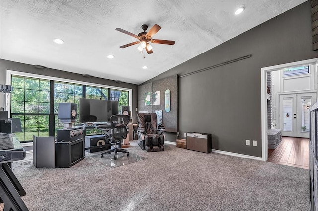 office featuring carpet, french doors, vaulted ceiling, ceiling fan, and a textured ceiling