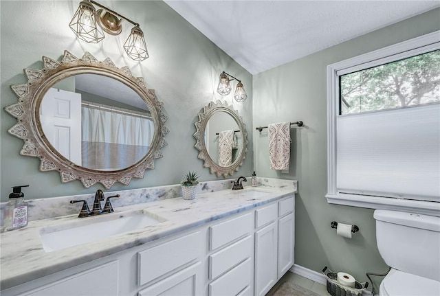 bathroom featuring vanity and toilet