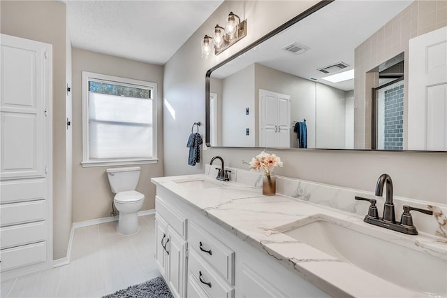 bathroom with tile patterned floors, toilet, and vanity