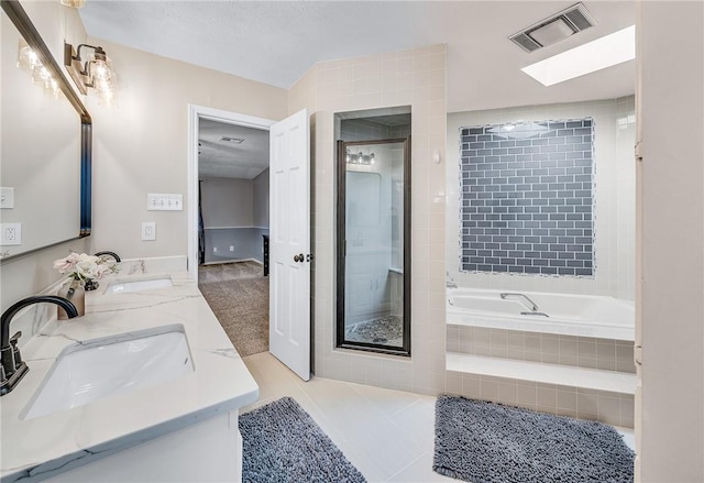 bathroom with vanity, tile patterned flooring, and shower with separate bathtub