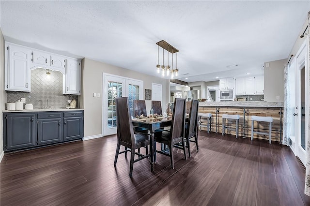 dining area featuring dark wood-type flooring