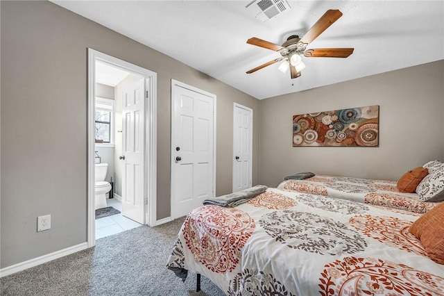 carpeted bedroom featuring ceiling fan and ensuite bath