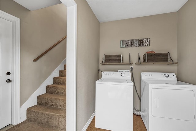 laundry area featuring wood-type flooring and washer and clothes dryer