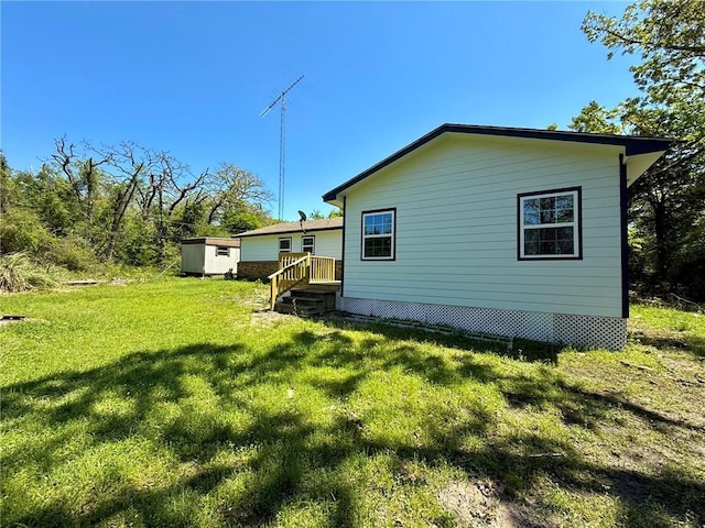 view of home's exterior featuring a shed, an outbuilding, and a yard