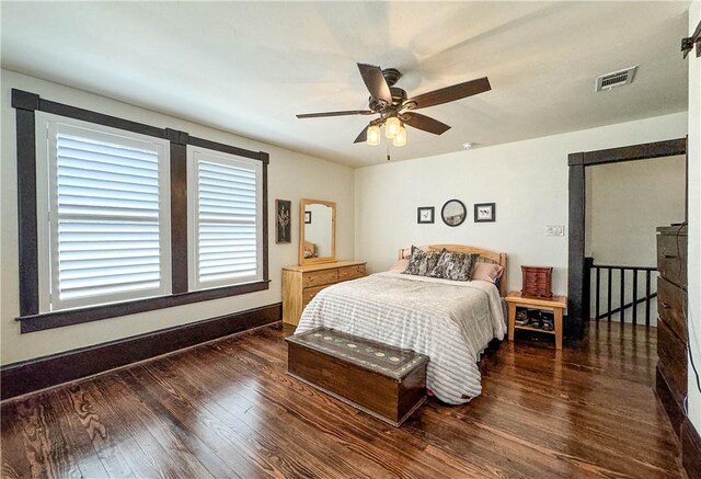 bedroom featuring ceiling fan and dark wood-type flooring