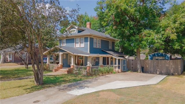 view of front of house featuring covered porch and a front yard