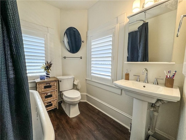 bathroom featuring hardwood / wood-style floors and toilet