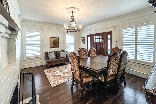 dining room featuring a wealth of natural light, dark hardwood / wood-style flooring, a chandelier, and ornamental molding