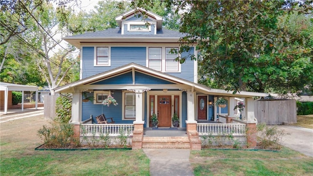 view of front of home with covered porch and a carport