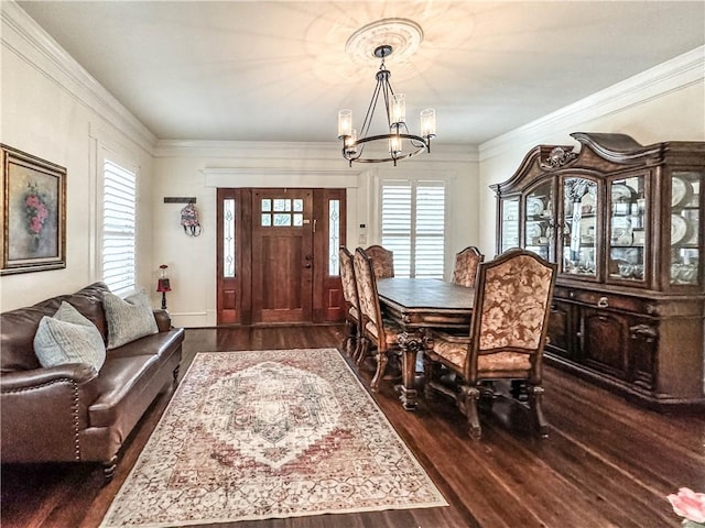 dining area with a notable chandelier, dark hardwood / wood-style flooring, and crown molding