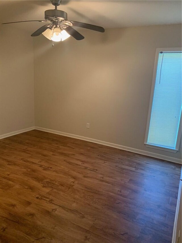 unfurnished room featuring dark hardwood / wood-style flooring and ceiling fan