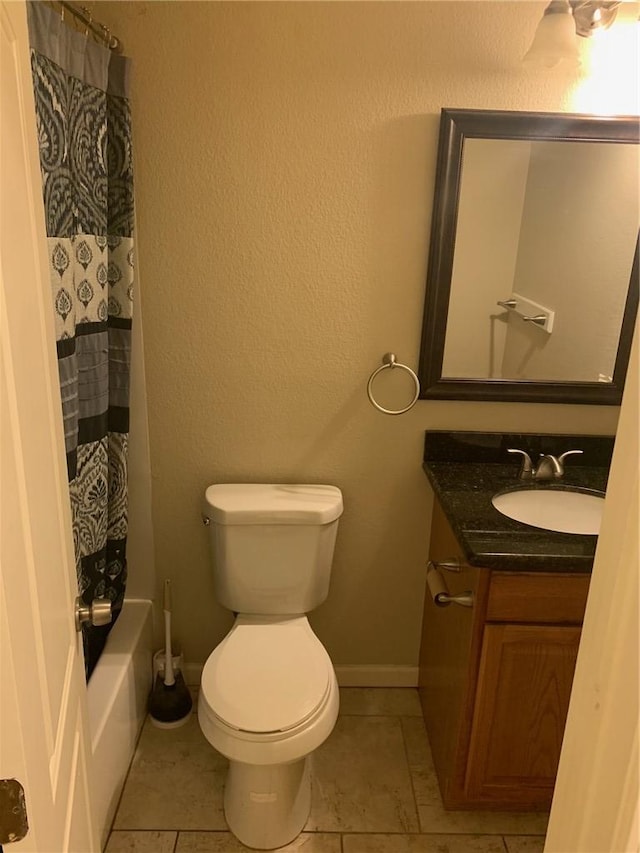 bathroom featuring tile patterned floors, vanity, and toilet