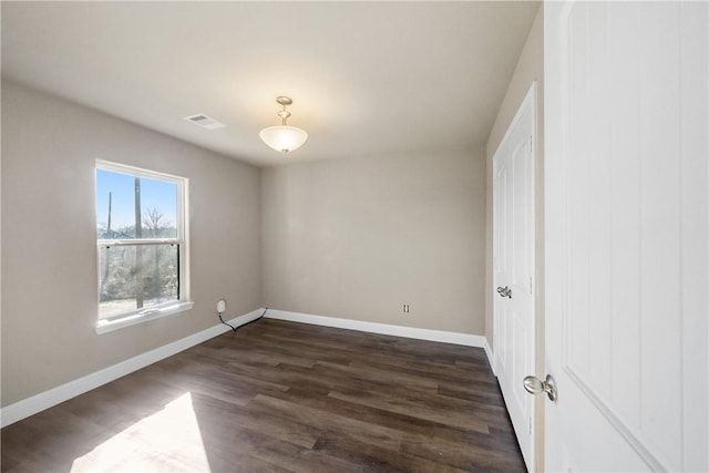 empty room with dark wood-type flooring