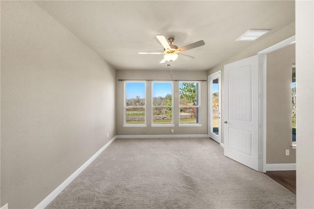 unfurnished room with ceiling fan and light carpet