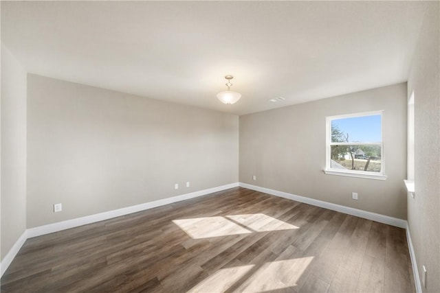 empty room with dark wood-type flooring