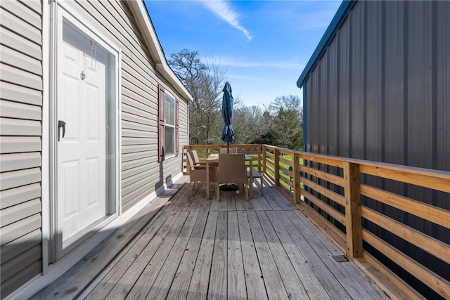 wooden deck featuring outdoor dining area