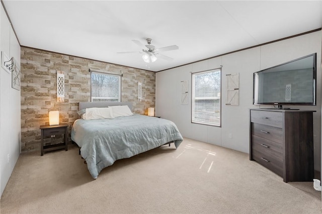 bedroom featuring multiple windows, light colored carpet, and ornamental molding