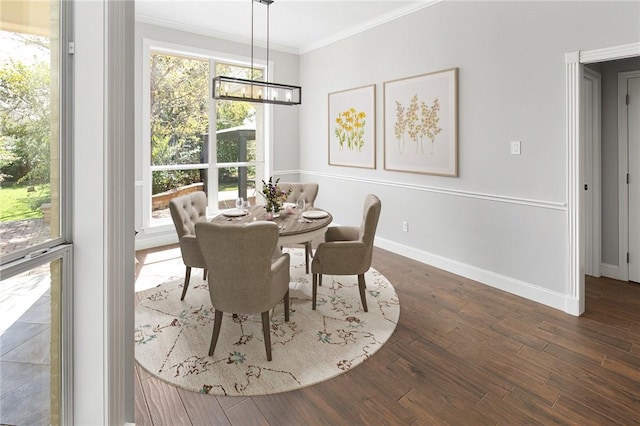 dining area with dark hardwood / wood-style floors and crown molding