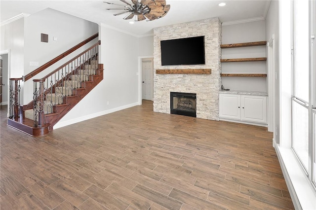 unfurnished living room with crown molding, a fireplace, and hardwood / wood-style flooring