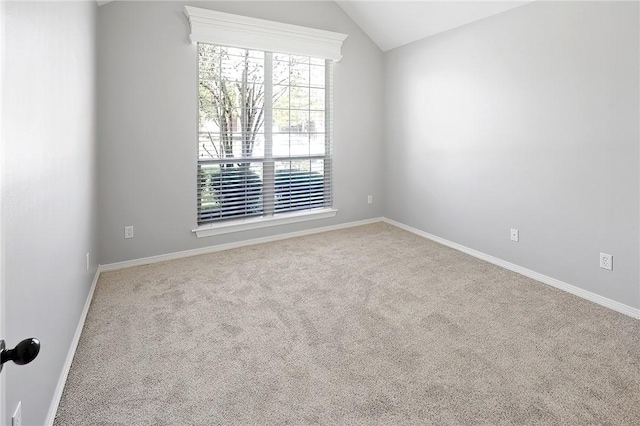 unfurnished room featuring carpet flooring and lofted ceiling