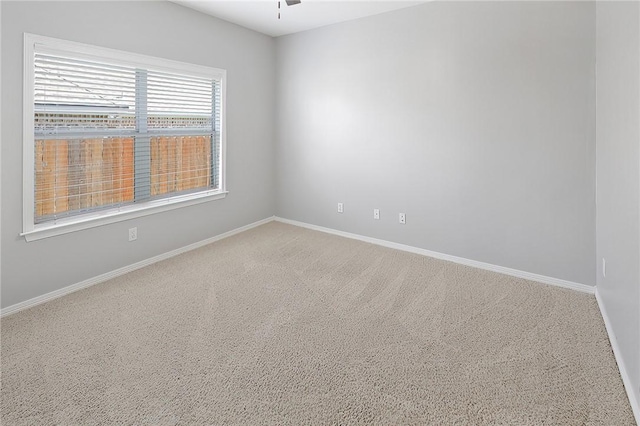 empty room featuring carpet flooring and ceiling fan