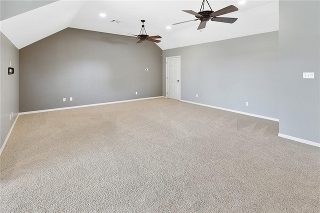 empty room featuring ceiling fan, light carpet, and vaulted ceiling