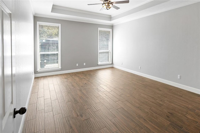 spare room with hardwood / wood-style flooring, ceiling fan, crown molding, and a tray ceiling