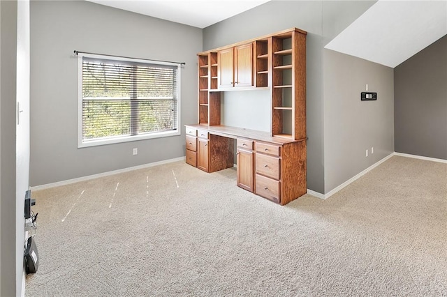 unfurnished office with light colored carpet and built in desk