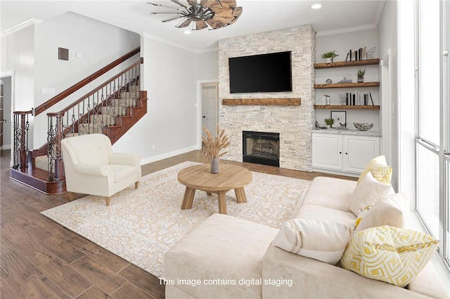 living room with a fireplace, crown molding, and dark wood-type flooring