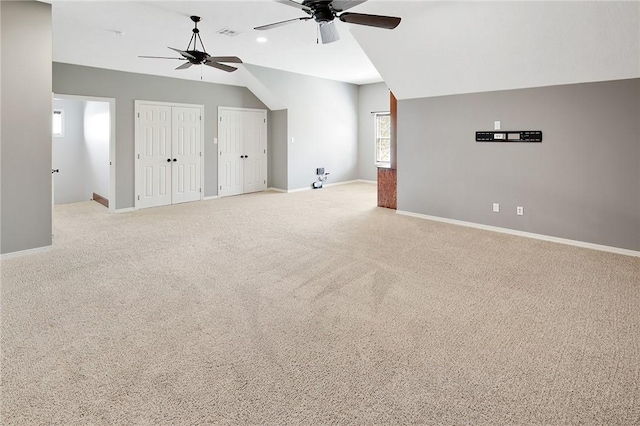 bonus room with light carpet, ceiling fan, and lofted ceiling