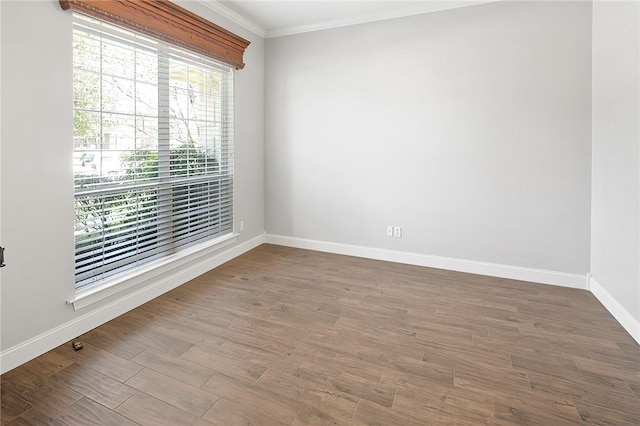 spare room featuring hardwood / wood-style floors and ornamental molding