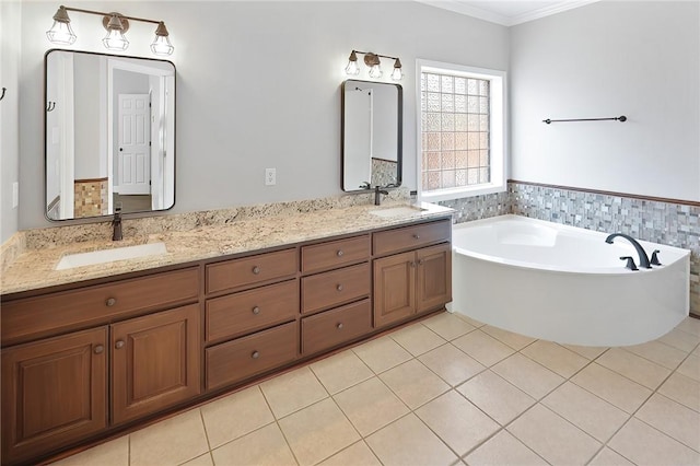 bathroom featuring tile patterned flooring, vanity, a tub, and ornamental molding