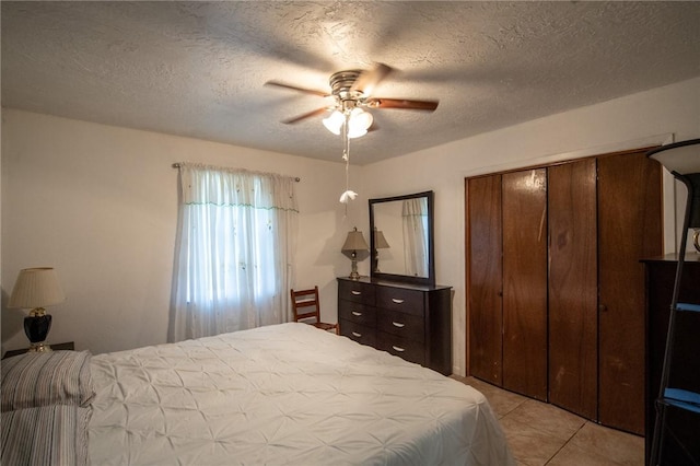 885 7th St, Somerville, TX 77879 - bedroom featuring a closet, ceiling fan, light tile patterned flooring, and a textured ceiling