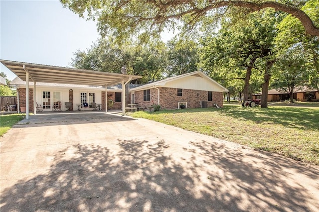 885 7th St, Somerville, TX 77879 - rear view of property with concrete driveway, a yard, brick siding, and a carport