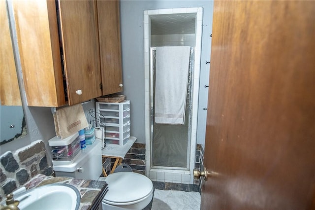 885 7th St, Somerville, TX 77879 - bathroom featuring a shower stall, toilet, and vanity