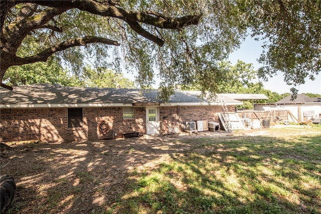 885 7th St, Somerville, TX 77879 - rear view of house featuring brick siding and a yard
