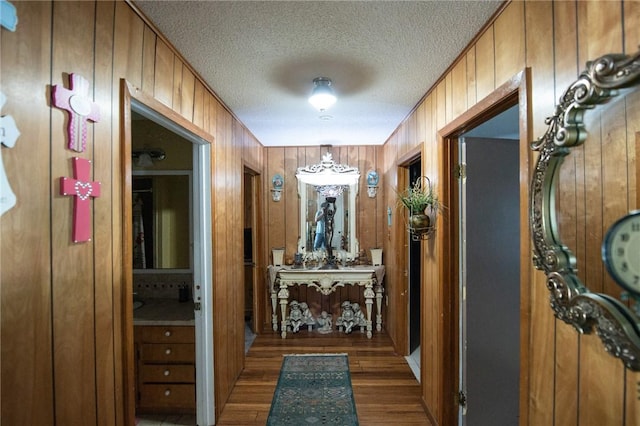 885 7th St, Somerville, TX 77879 - hall featuring a textured ceiling, wood finished floors, and wood walls