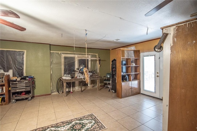 885 7th St, Somerville, TX 77879 - unfurnished room with a ceiling fan, tile patterned flooring, and crown molding