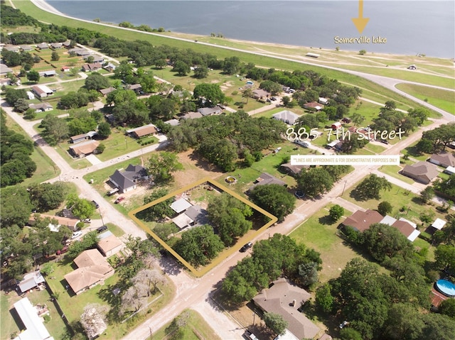 885 7th St, Somerville, TX 77879 - aerial view of residential area featuring property parcel outlined and a nearby body of water