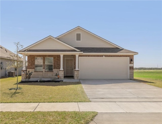 view of front facade with driveway, an attached garage, cooling unit, a front lawn, and brick siding