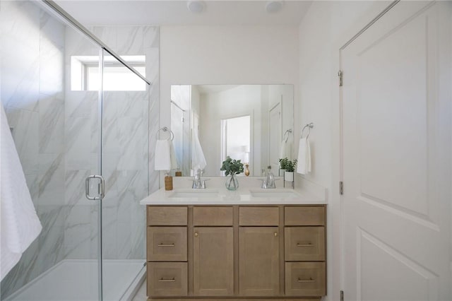 bathroom featuring vanity and a shower with shower door