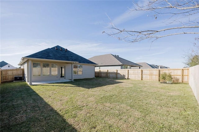 rear view of property with a lawn and central AC