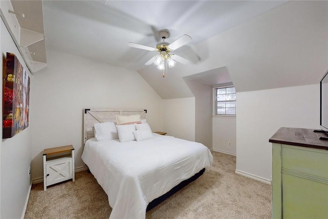 bedroom featuring a ceiling fan, baseboards, light colored carpet, and vaulted ceiling