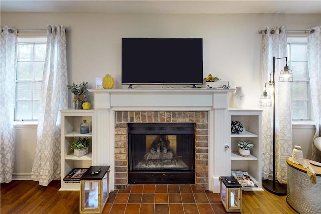 details featuring a fireplace and wood finished floors