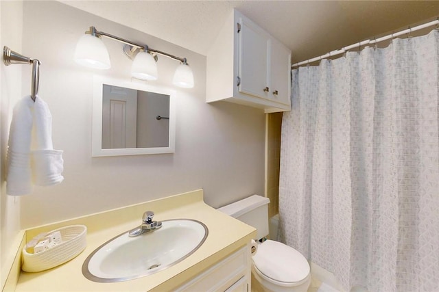 bathroom with vanity, a shower with shower curtain, and toilet