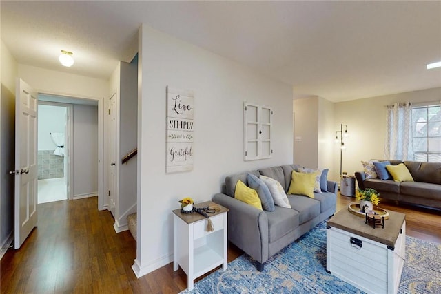 living room with baseboards, stairs, and wood finished floors