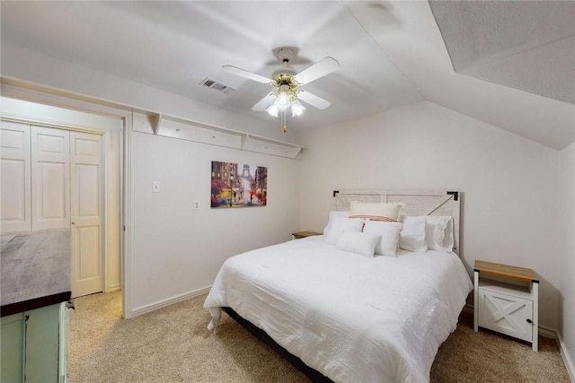 carpeted bedroom with ceiling fan, visible vents, baseboards, and lofted ceiling