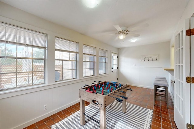 playroom featuring baseboards, a ceiling fan, and tile patterned floors